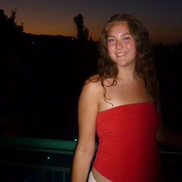 Woman smiling at the character in front of a sunset